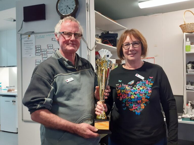 Tournament winners holding a trophy